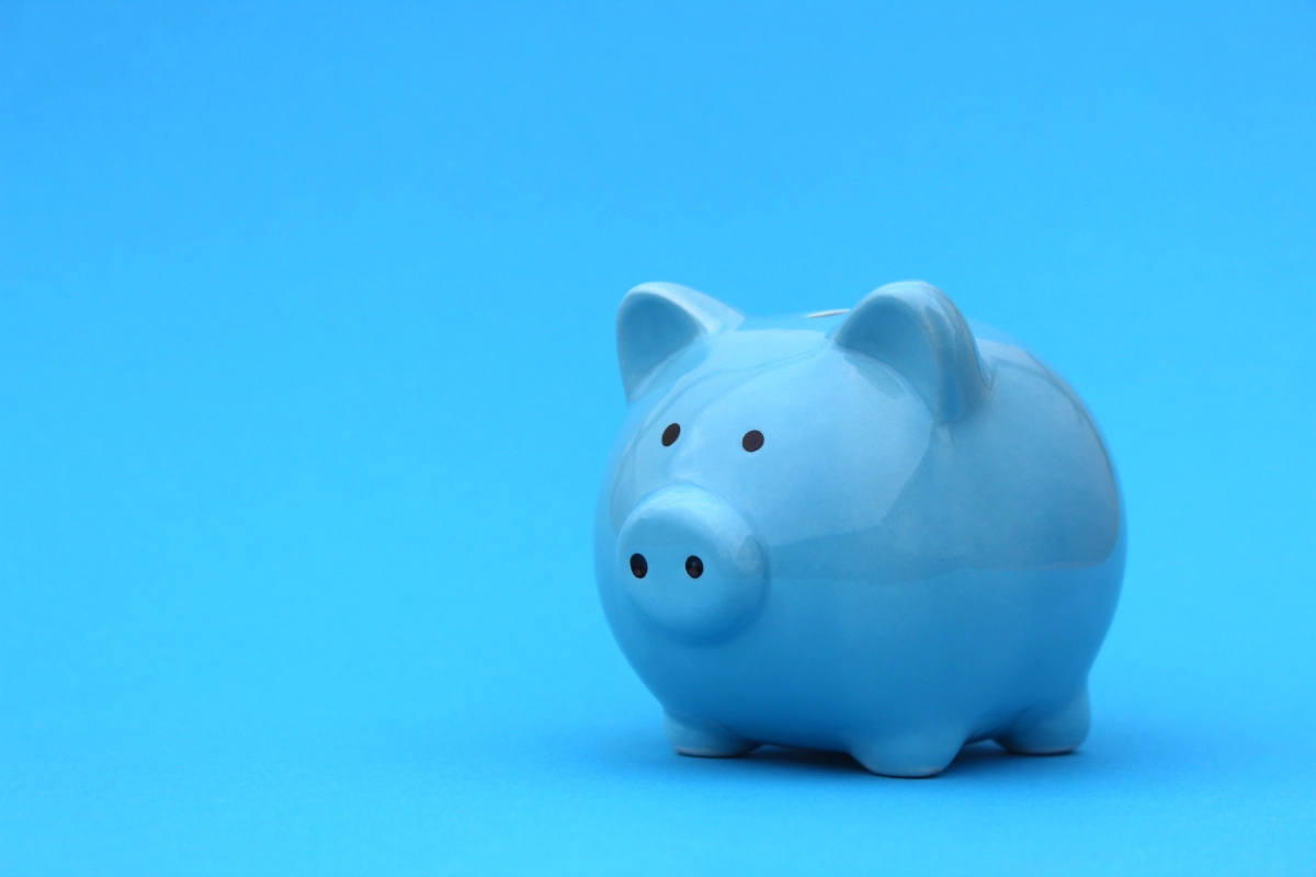 Blue Piggy Bank On Blue Background 1200X800